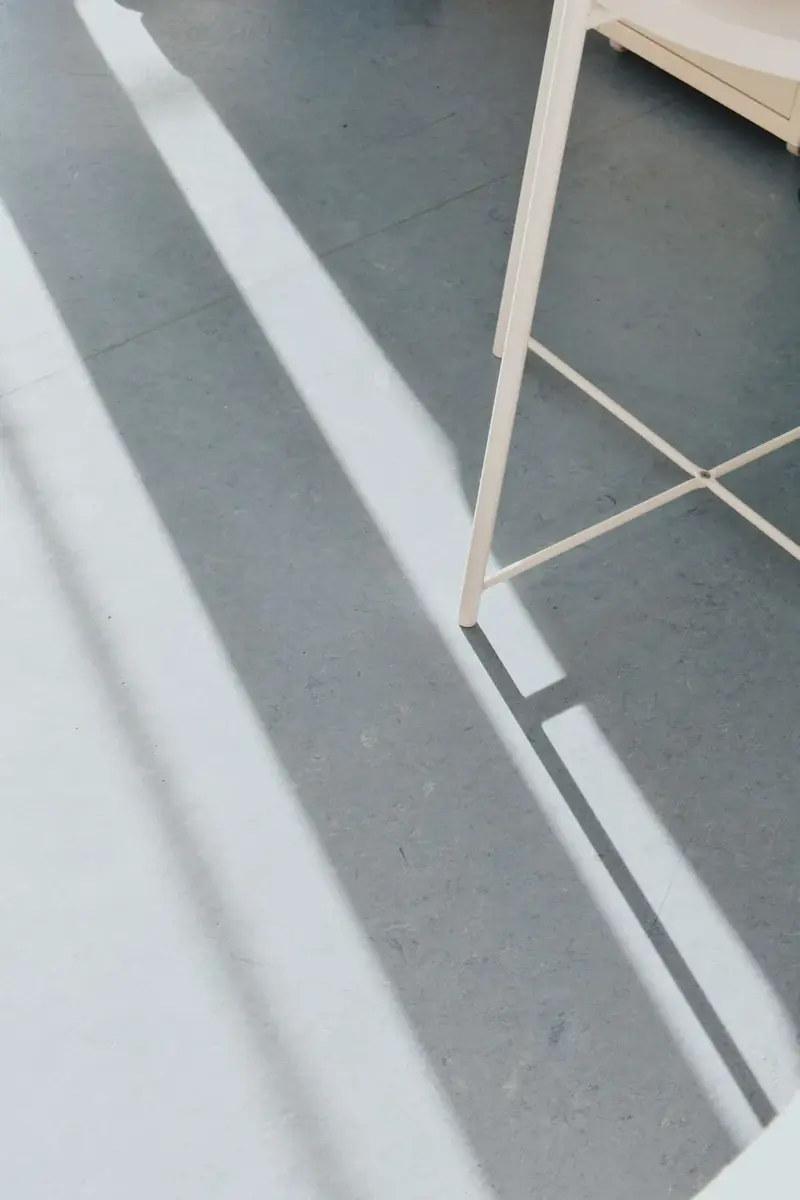 a honed grey concrete floor in hard window light
